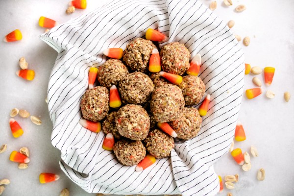 halloween energy balls in a bowl surrounded by candy corn