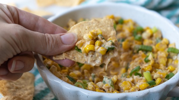 tortilla chip scooping up cajun corn dip