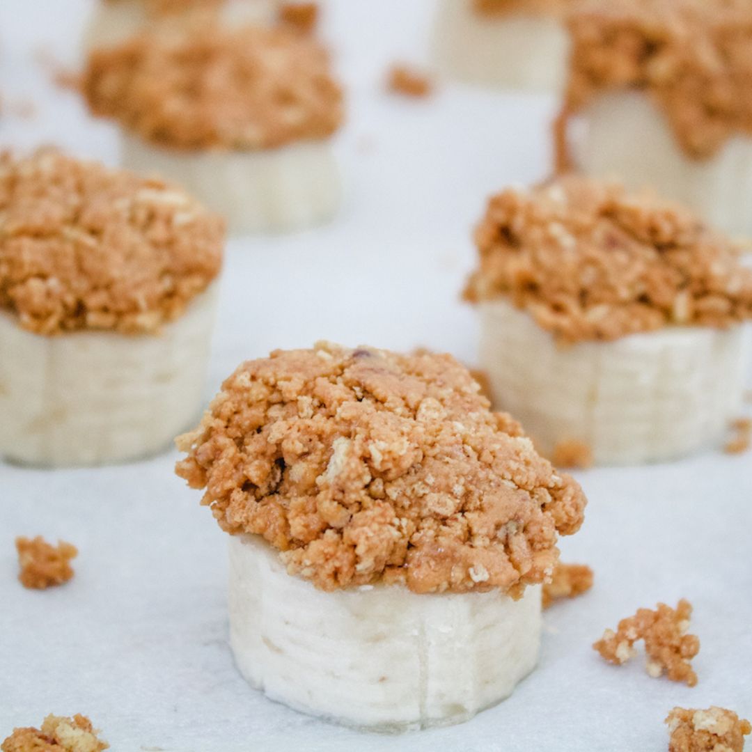 frozen peanut butter banana bites on parchment paper