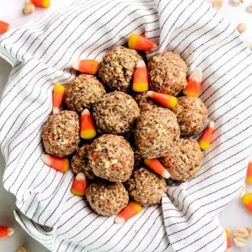 halloween energy bites in a bowl surrounded by candy corn