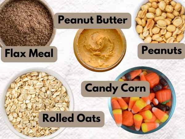 bowls of ingredients for halloween energy balls including flax meal, peanut butter, peanuts, candy corn, and rolled oats