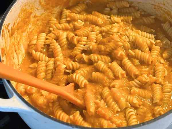 white pot with noodles and creamy orange hidden veg pasta sauce