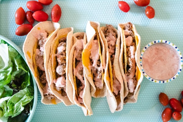 tray full of cheesy gordita crunch copycats made with egg based tortillas