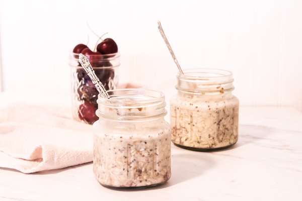 two mason jars with cherry and peanut butter overnight oats