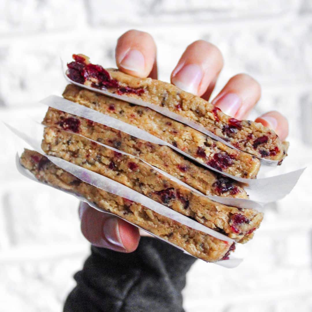hand holding four homemade sunflower seed butter granola bars